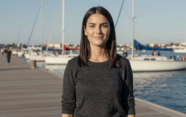 Woman on a marina waterfront on the navy dating category
