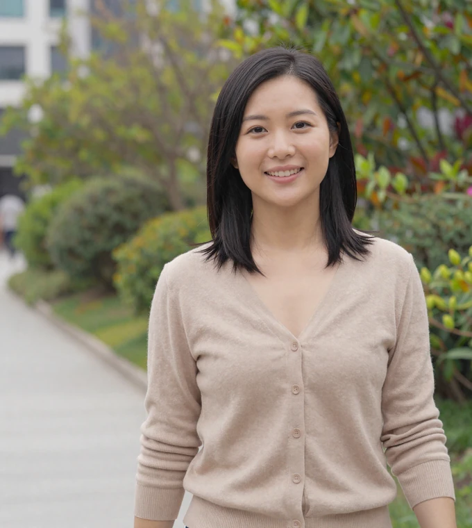 Asian woman smiling on a city walk near a botanical garden, a member of our uniform dating community